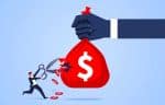 Little businessman holding scissors to cut money bag in giant hand - what is wage theft concept?