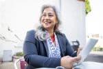 An older businesswoman using a tablet and smartphone - age discrimination in the workplace concept