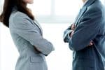 Two businesspeople standing face to face - mediation in employment disputes concept